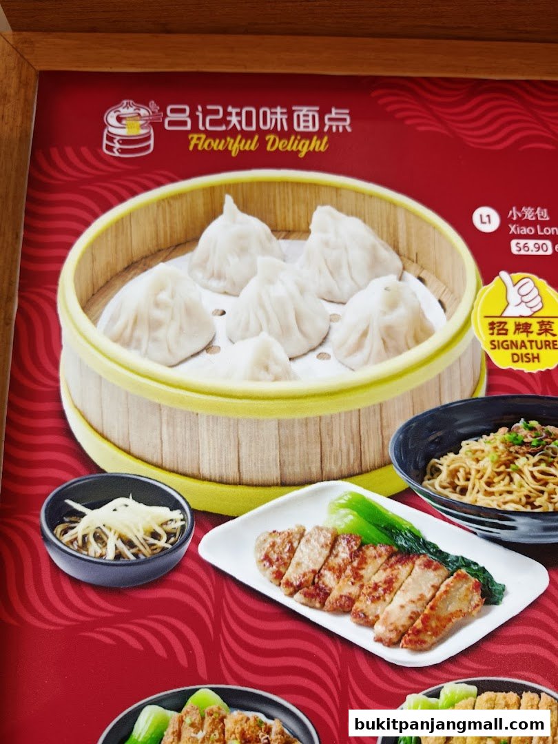 A close-up of a menu featuring steamed dumplings, sliced meat, and noodles.