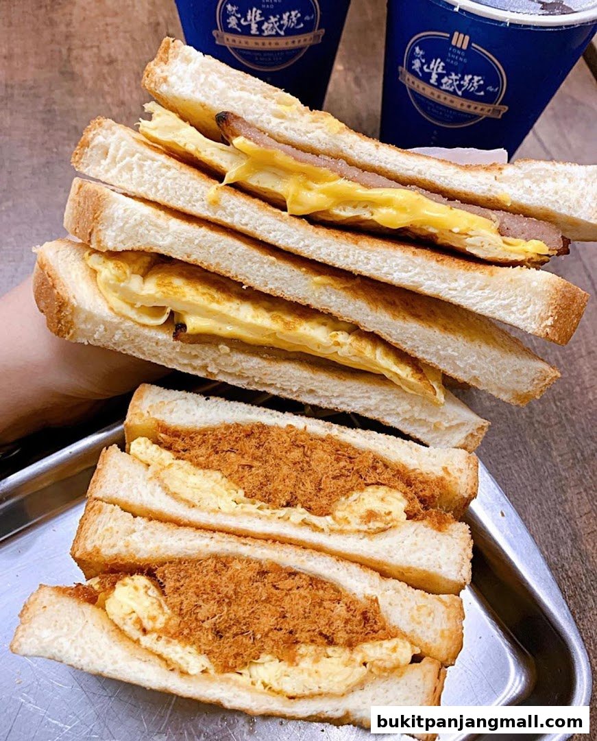 A stack of delicious sandwiches with meat floss and egg, served with drinks.