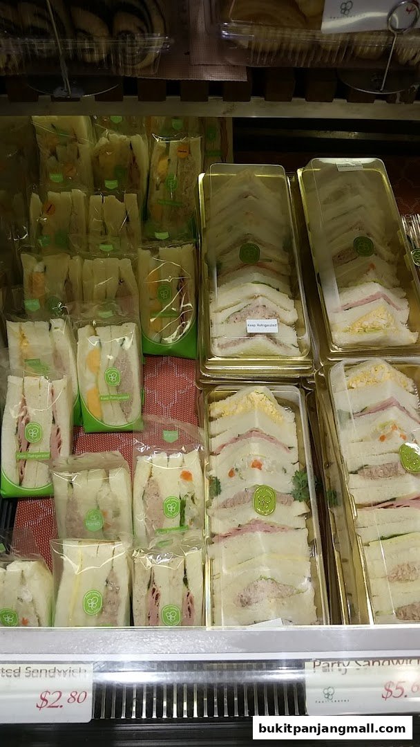 A display of assorted pre-packaged sandwiches in clear plastic containers.