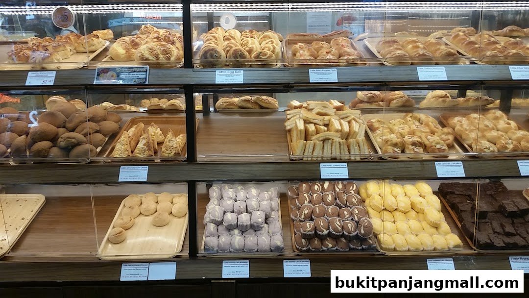 A display case filled with a variety of freshly baked breads, pastries, and desserts.