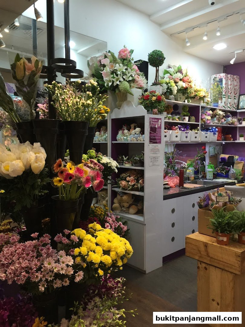 A vibrant flower shop interior filled with a wide variety of fresh and artificial floral arrangements.