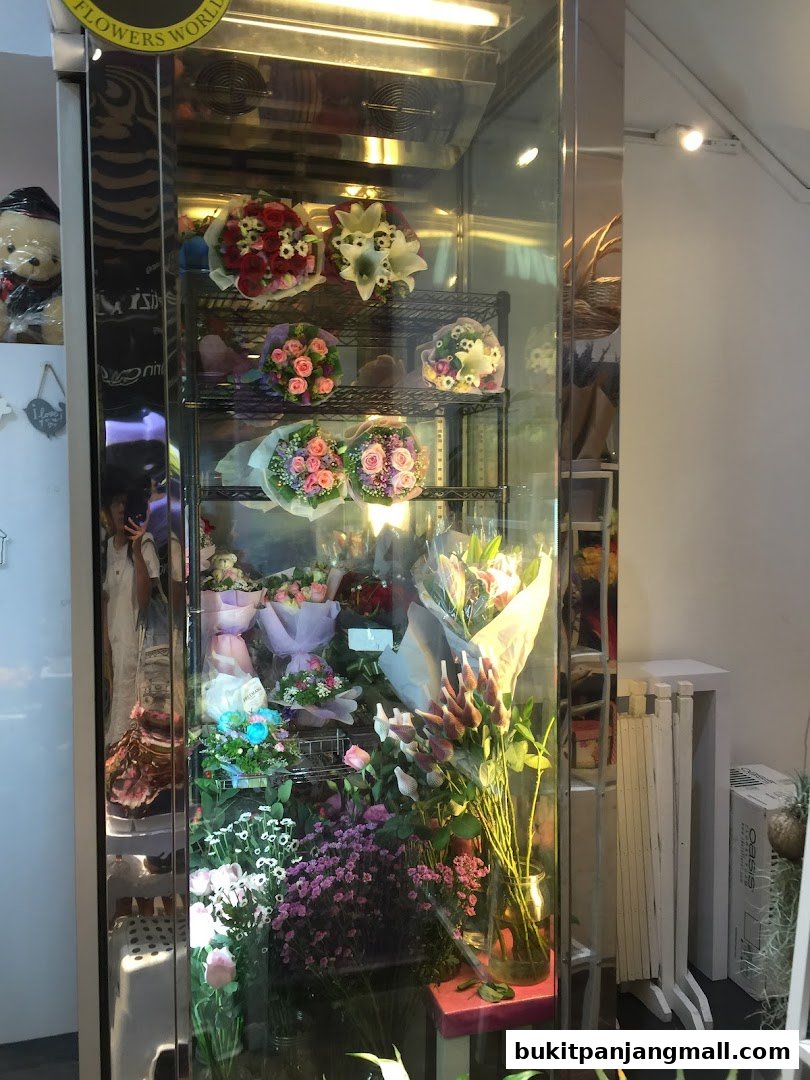 A display cooler filled with various bouquets and arrangements of fresh flowers.