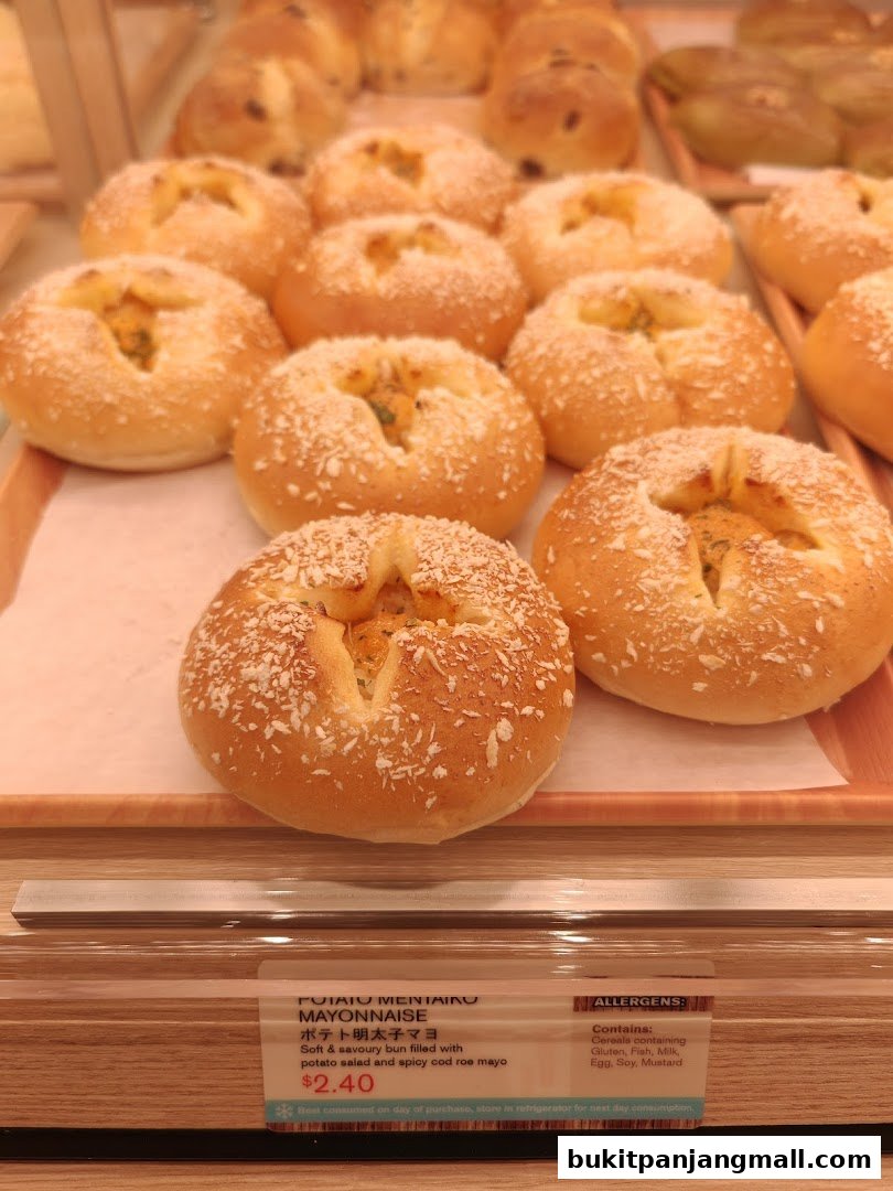A close-up of freshly baked Japanese buns filled with potato salad and spicy cod roe mayo.