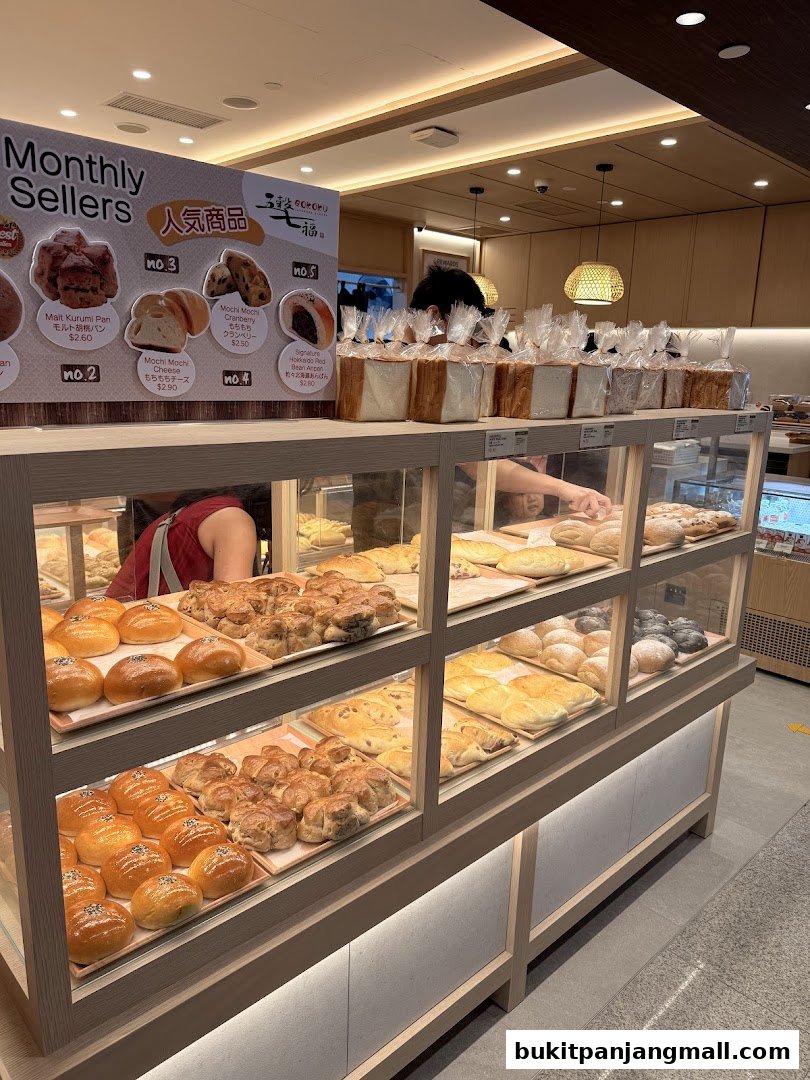 Interior view of a Japanese bakery showcasing a variety of freshly baked breads and pastries.