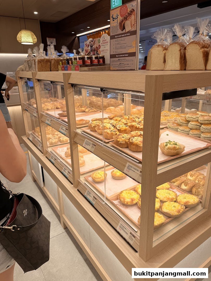 A display of freshly baked bread and pastries in a modern bakery.