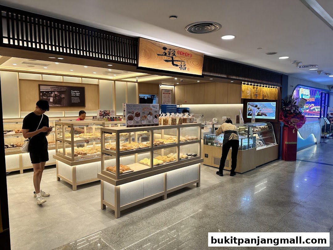 Interior view of Gokoku Japanese Bakery with display cases full of bread and pastries.