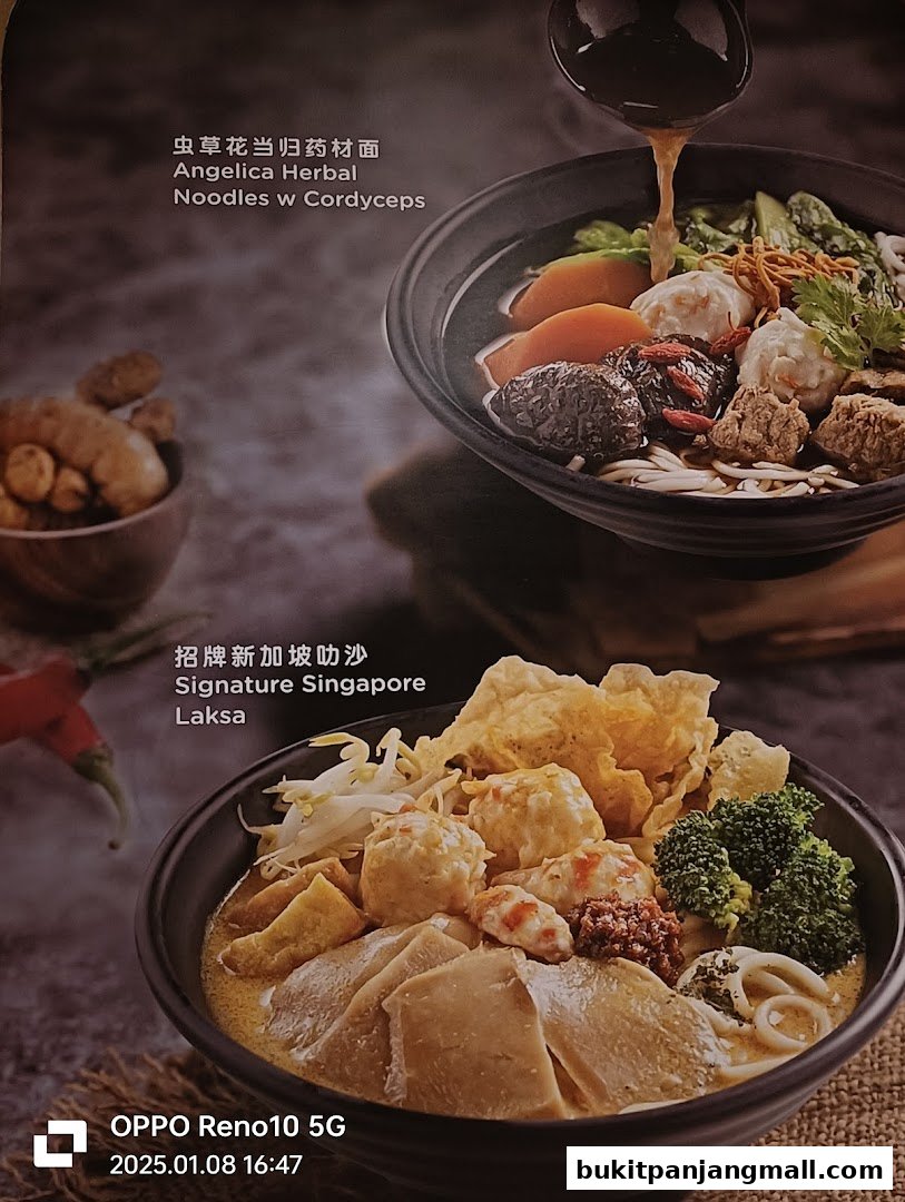 A close-up of two bowls of noodles, one herbal and one laksa.