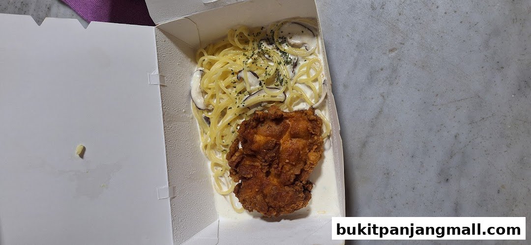 A takeout box filled with creamy mushroom pasta and a piece of fried chicken.