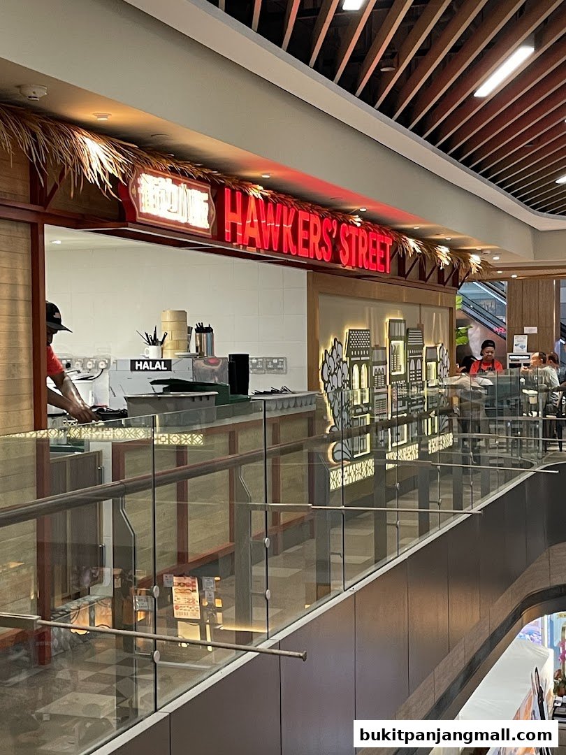 The entrance of Hawkers Street BPP with a prominent neon sign and a food counter.