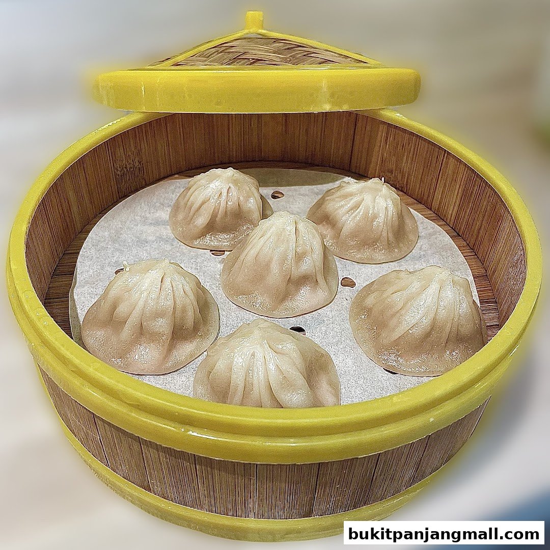 A close-up shot of delicious soup dumplings served in a traditional bamboo steamer.