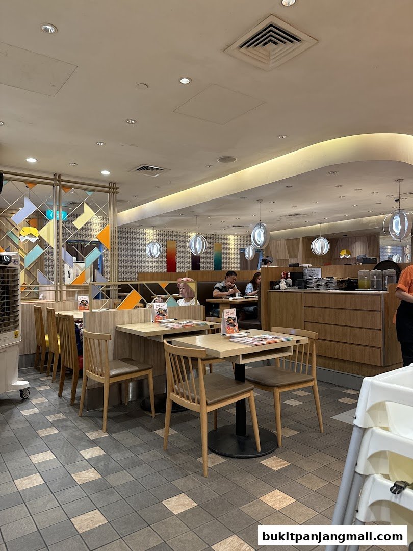 Interior view of Ichiban Sushi Bukit Panjang with tables, chairs, and diners.