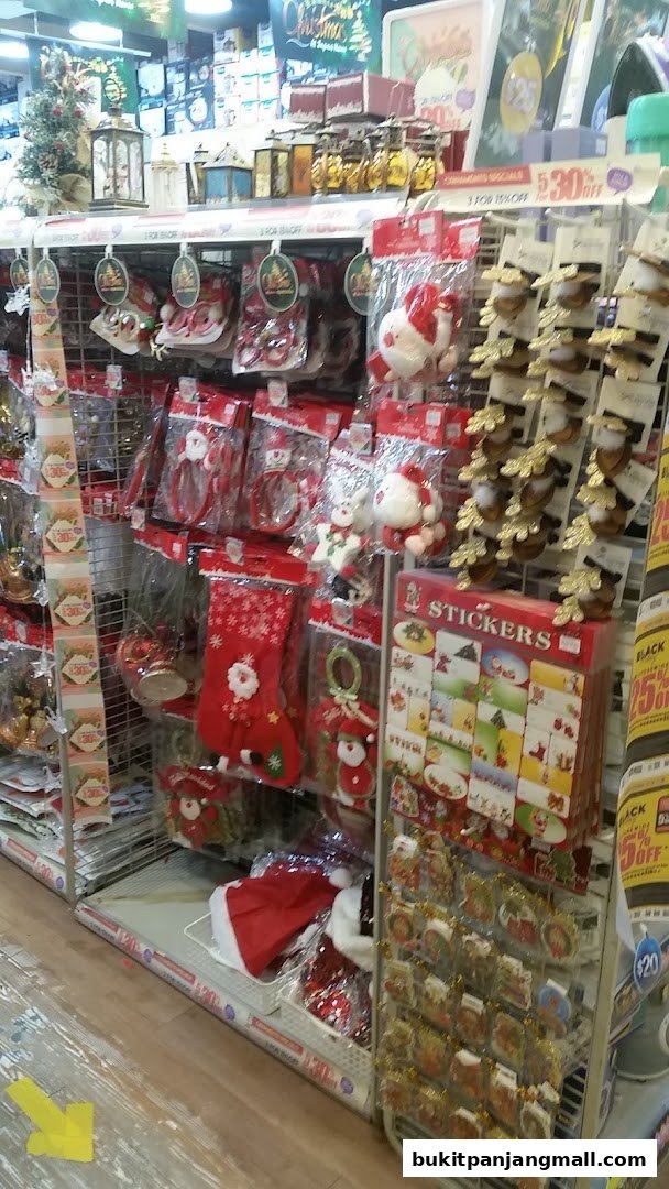 A retail display filled with Christmas-themed decorations and accessories, including stockings, ornaments, and stickers.