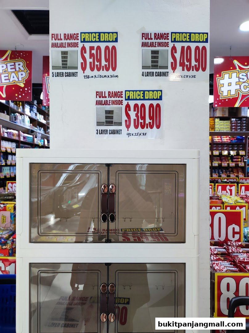 Price drop signs for cabinets and shelves stocked with products in a retail store.