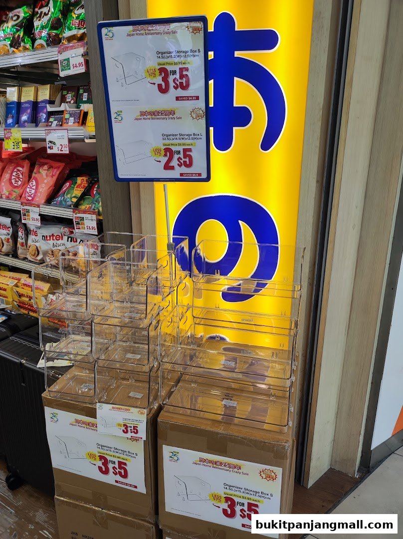 Japan Home store display featuring organizer boxes on sale and snacks on shelves.