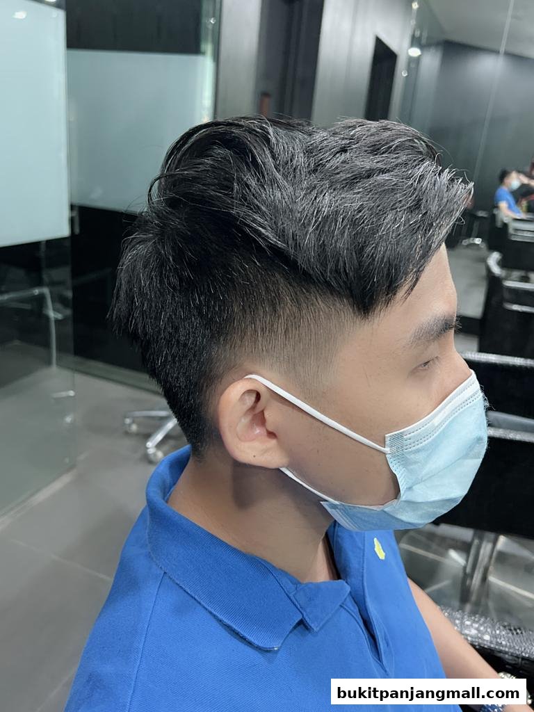 A man with a stylish haircut and a face mask at a hair salon.