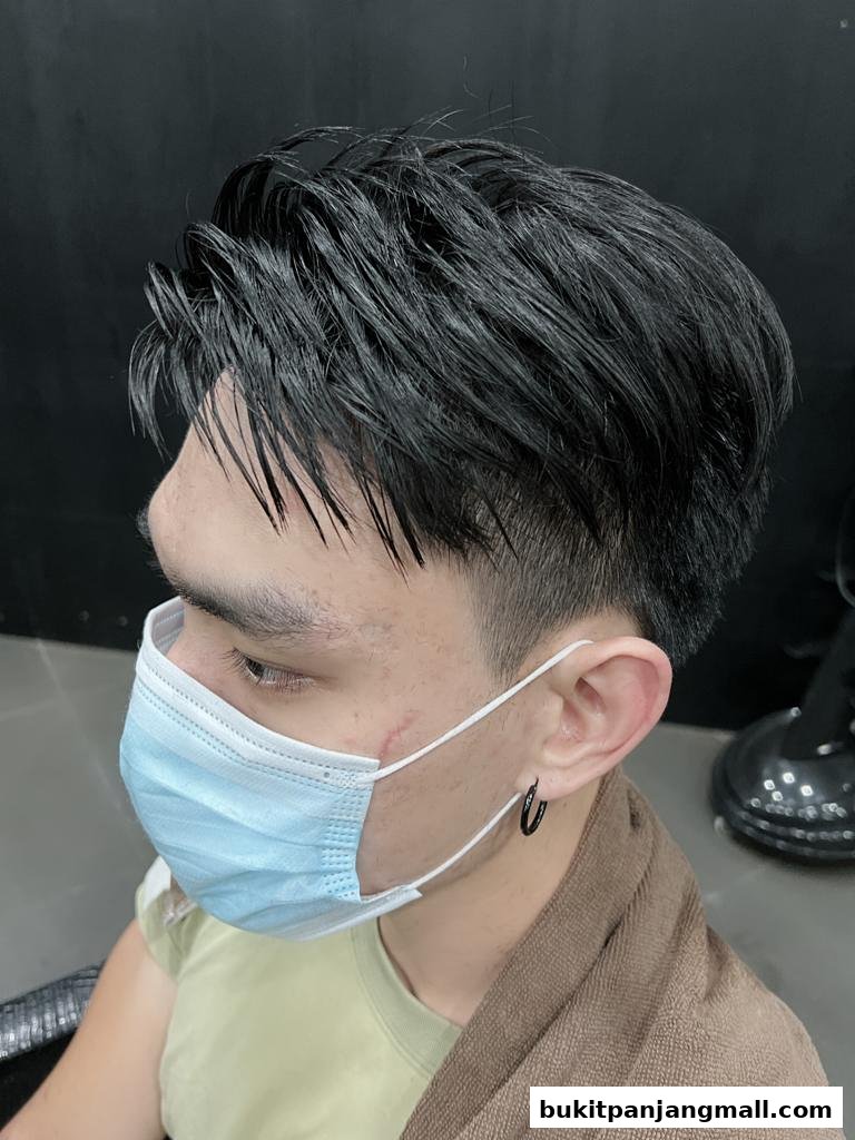A man with a fresh haircut and a face mask at a salon.