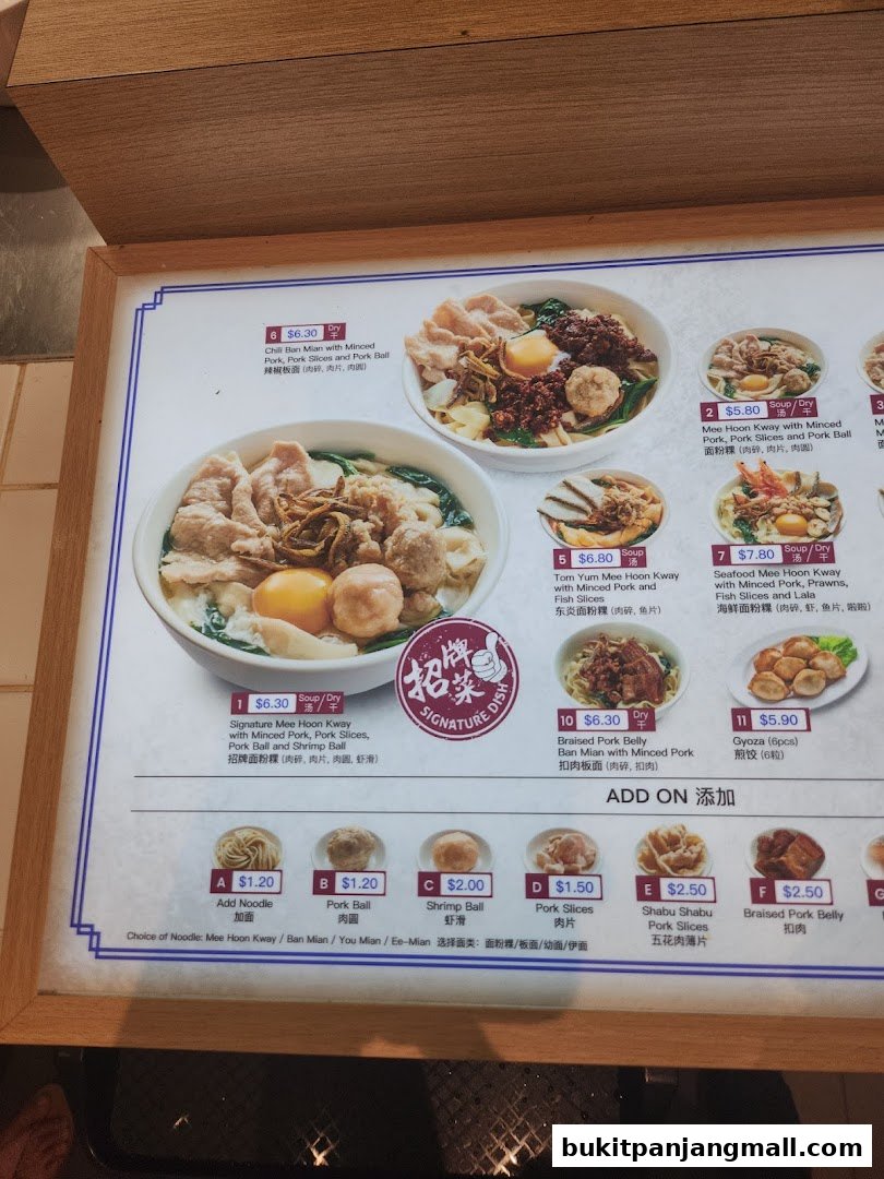 A menu board displaying various noodle dishes with prices and images.