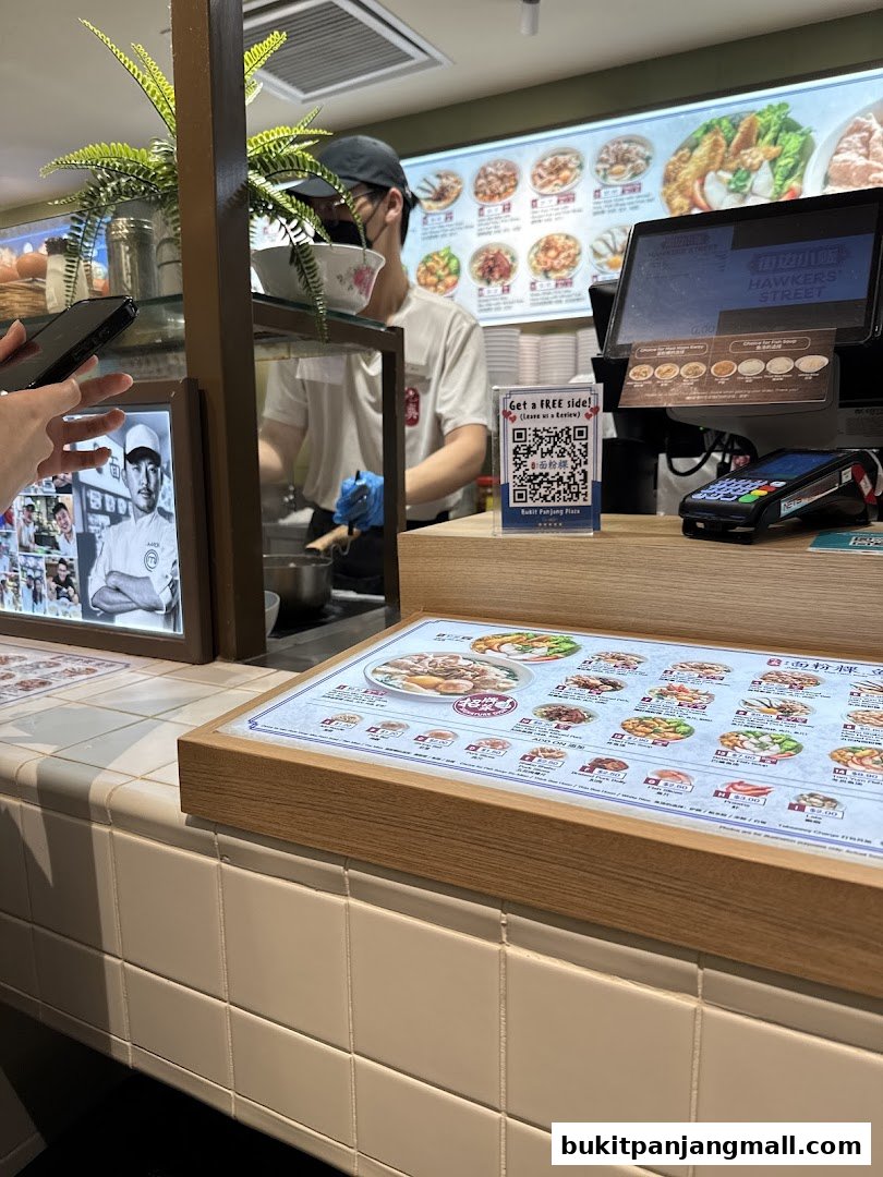 A close-up of a menu at Jiak Song Mee Hoon Kway, showing various noodle dishes and prices.