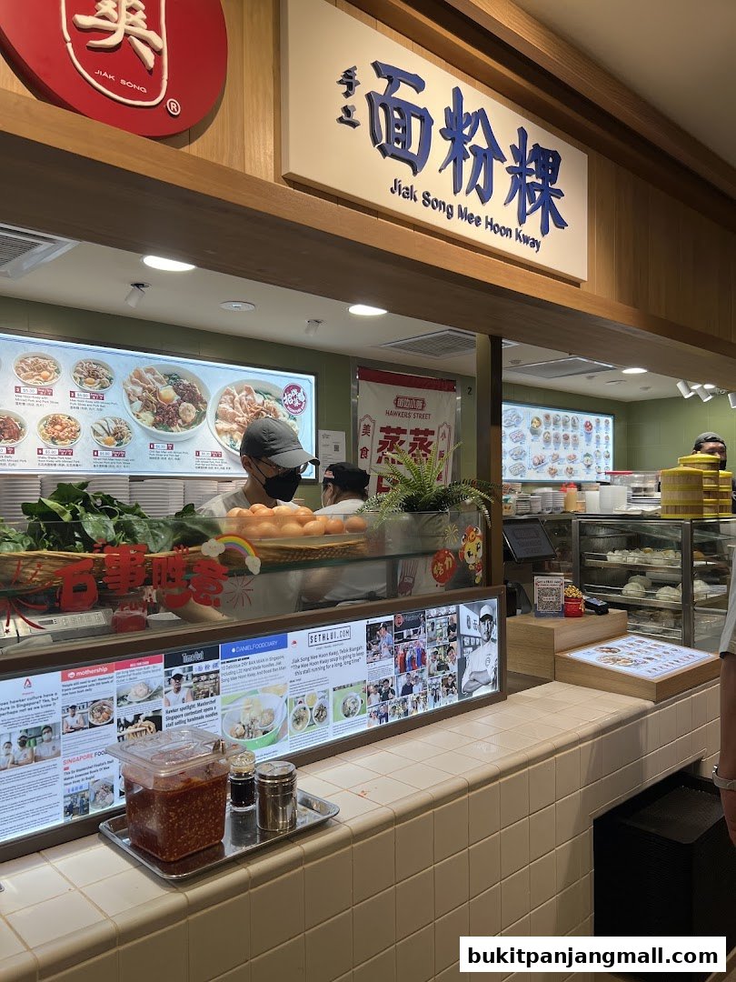 The Jiak Song Mee Hoon Kway shop front with a menu display and staff behind the counter.