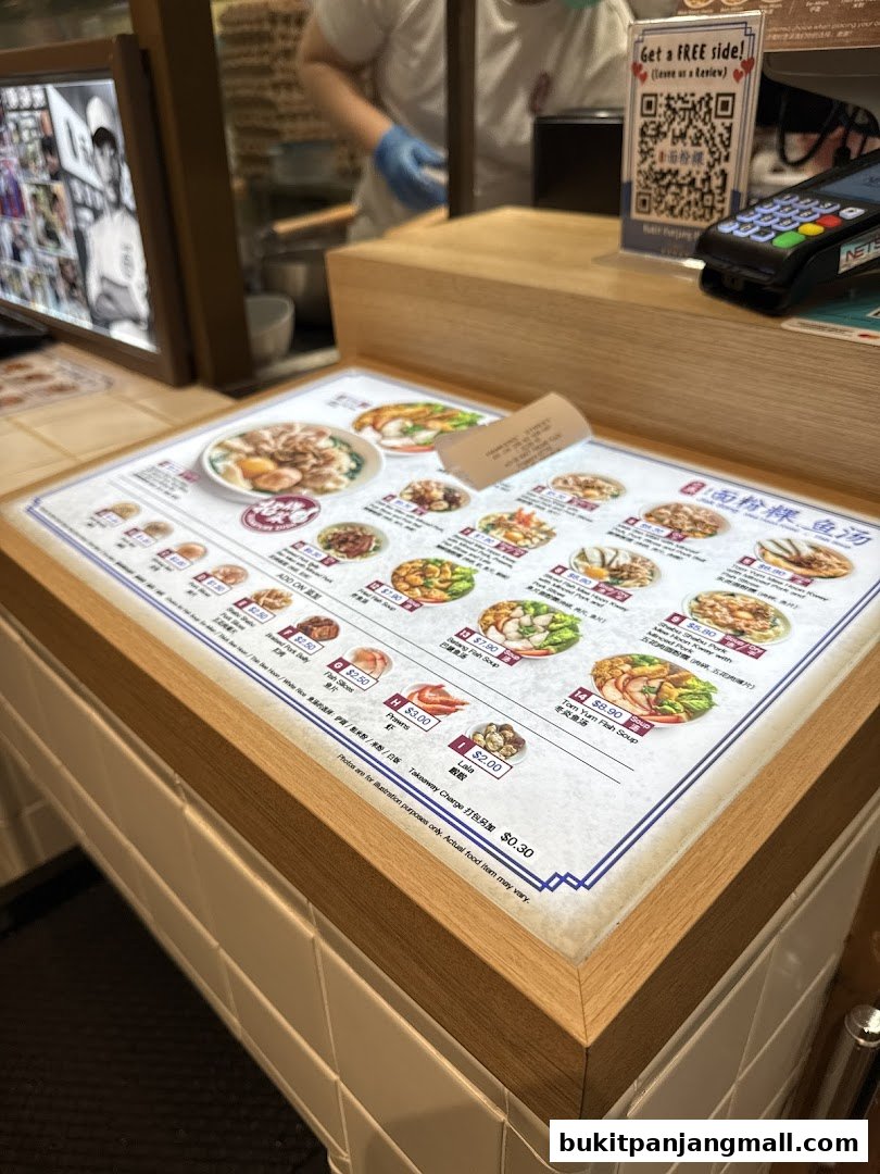 A close-up of a menu at Jiak Song Mee Hoon Kway, showcasing various noodle dishes with prices.