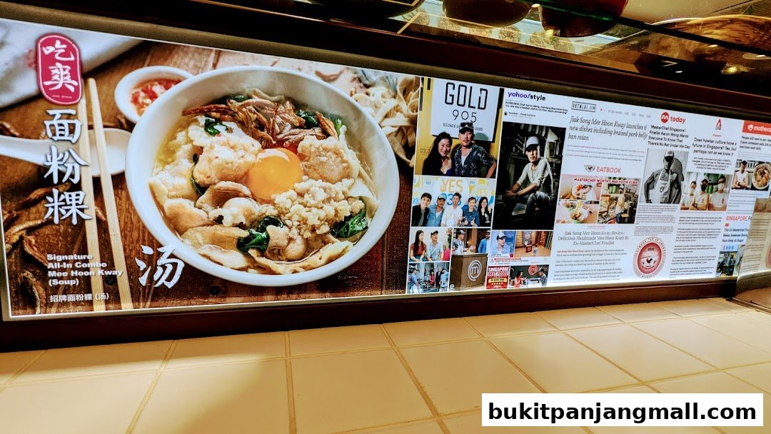 A display showcasing a bowl of Mee Hoon Kway and various media features about the restaurant.