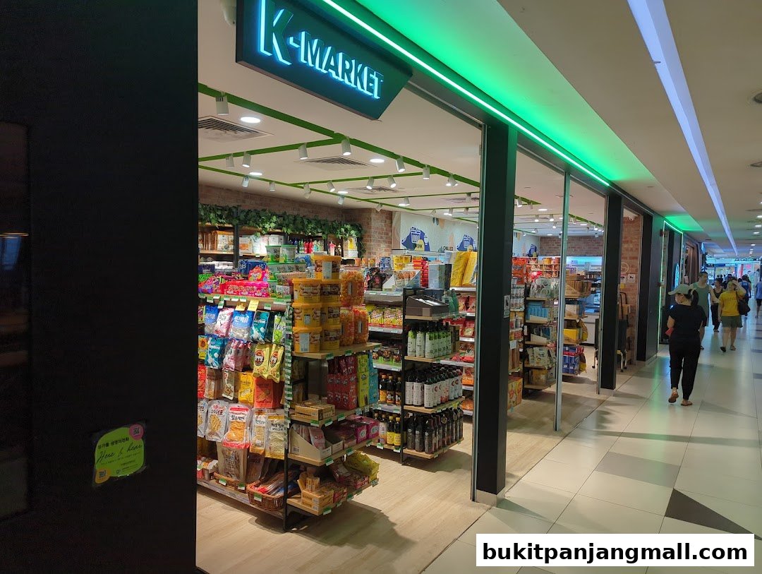 The entrance of K-market Koryo Mart, showcasing shelves stocked with various Korean snacks and products.