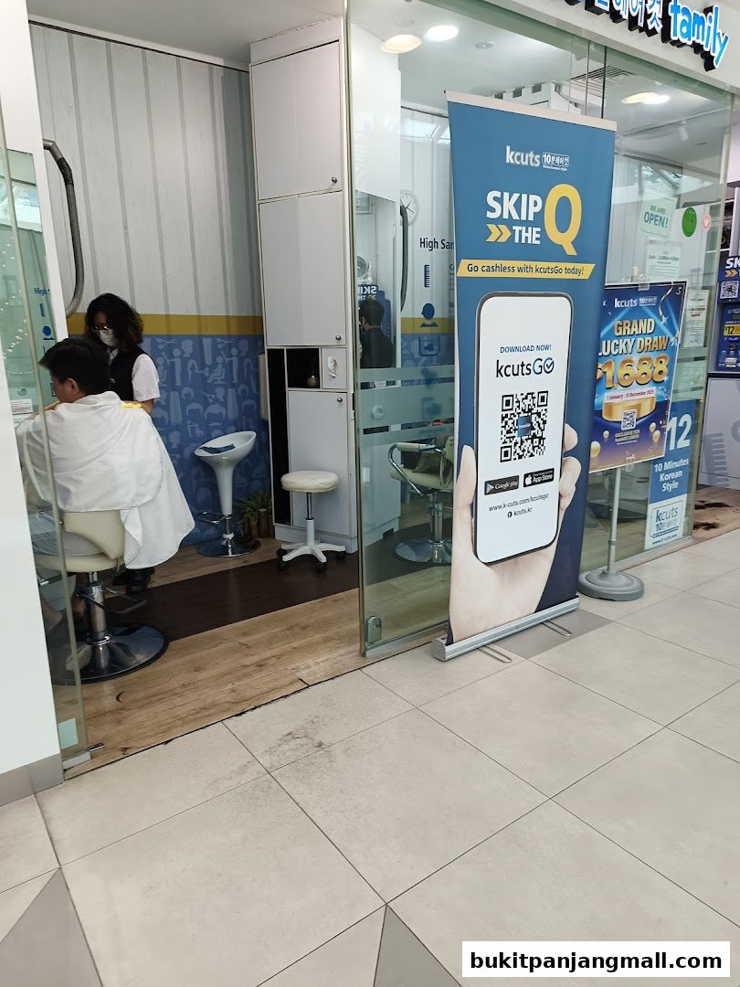 A kcuts hair salon with a customer getting a haircut and promotional banners outside.