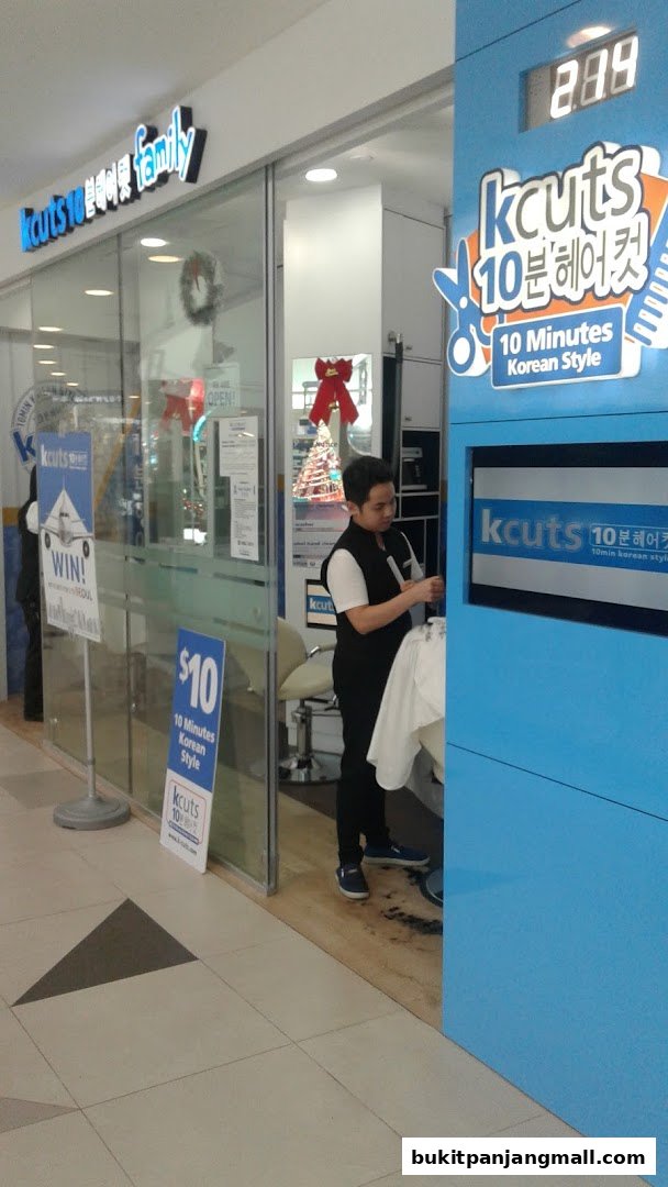 A barber is cutting hair at Kcuts, a 10-minute Korean style salon.
