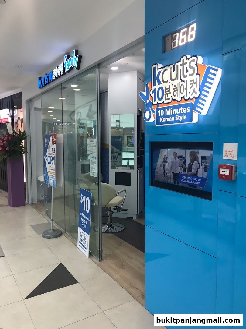 The exterior of a kcuts hair salon with a bright blue facade and glass doors.