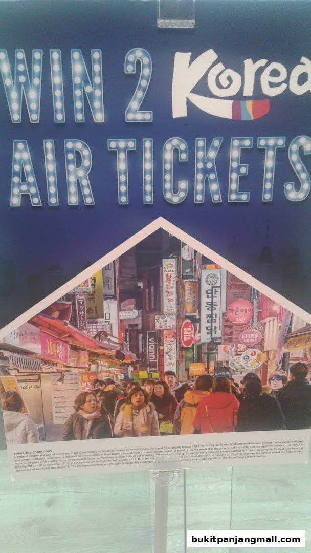 A promotional poster for winning air tickets to Korea, featuring a vibrant street scene.