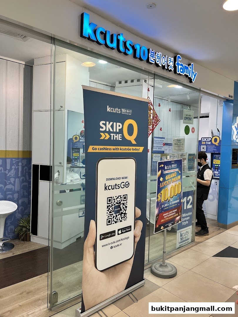 The exterior of a kcuts hair salon with a promotional banner and a staff member inside.
