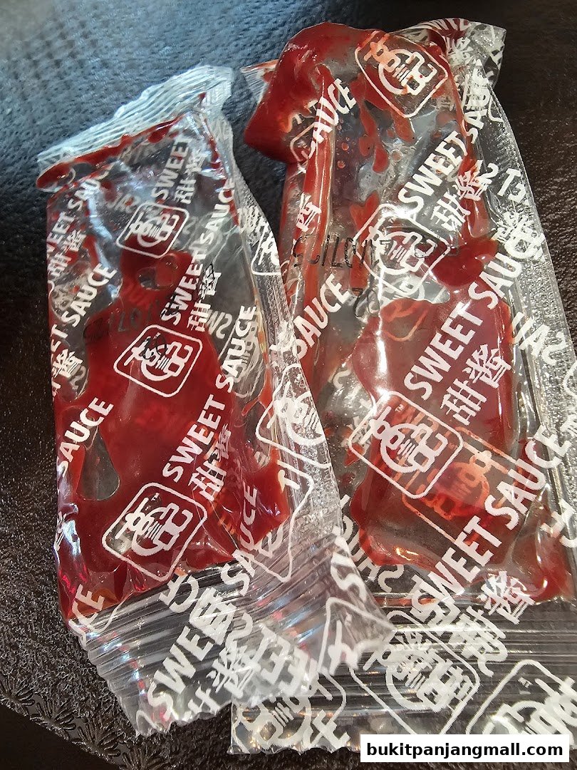 Two packets of Koo Kee sweet sauce, with visible branding and Chinese characters.