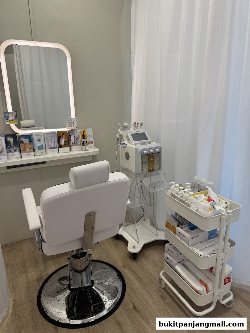 A clean and modern facial treatment room with a chair, mirror, and beauty equipment.