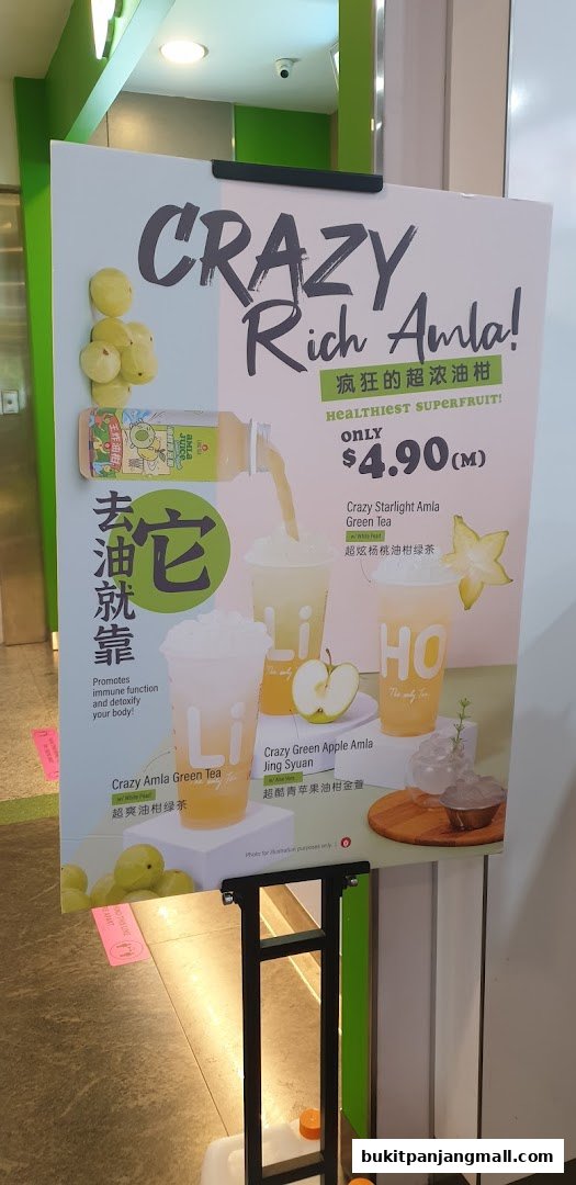 A sign advertising LiHO TEA's Crazy Rich Amla drinks with prices and descriptions.