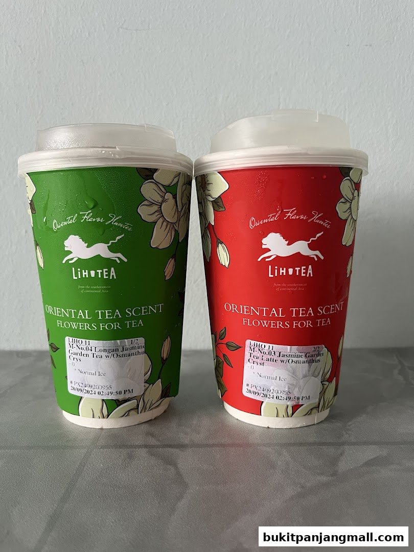 Two LiHO TEA drinks, one green and one red, with floral designs and branding.