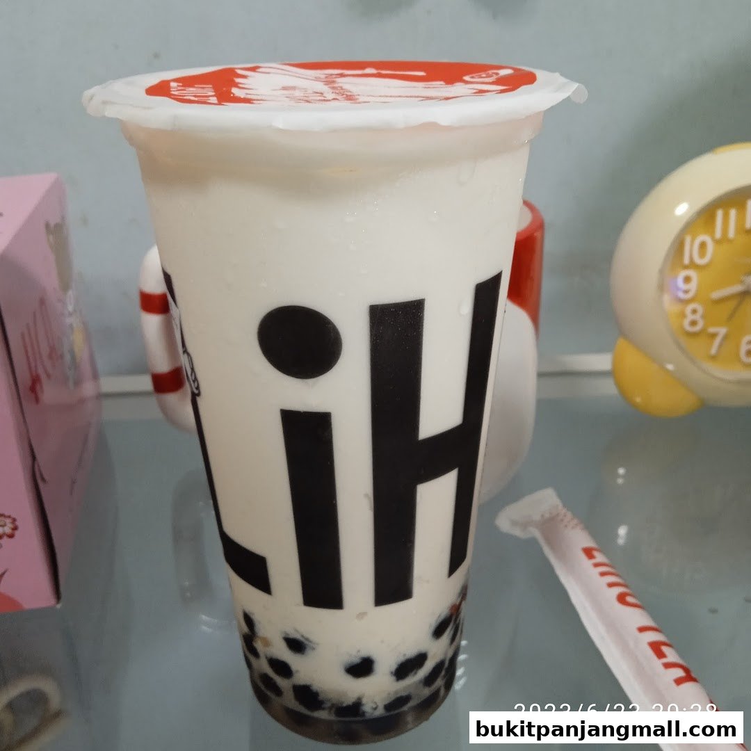 A close-up of a LiHO TEA bubble tea with the brand logo visible.