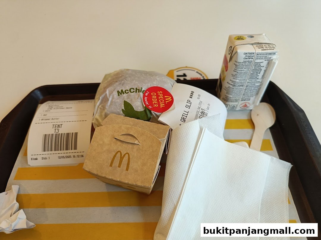 A tray of McDonald's food including a McChicken burger, fries, and a carton of oat milk.