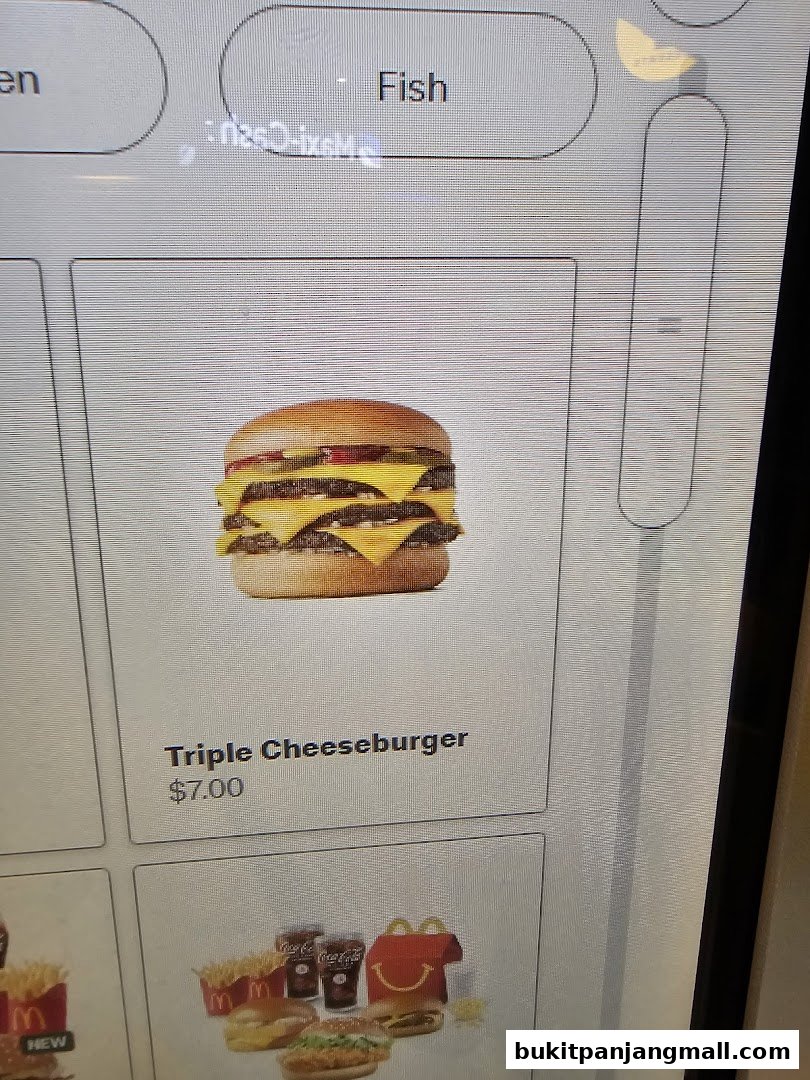 A digital menu displaying a Triple Cheeseburger and other meal options.
