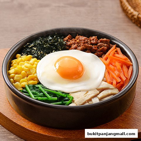 A close-up of a delicious bibimbap dish with a fried egg, vegetables, and meat.