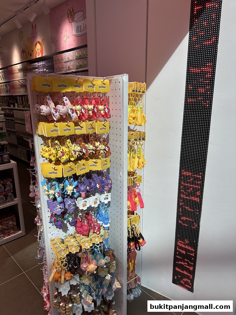 A display of various character keychains, including Pokemon, in a retail store.