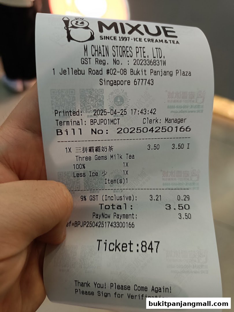 A receipt from Mixue showing a purchase of Three Gems Milk Tea.