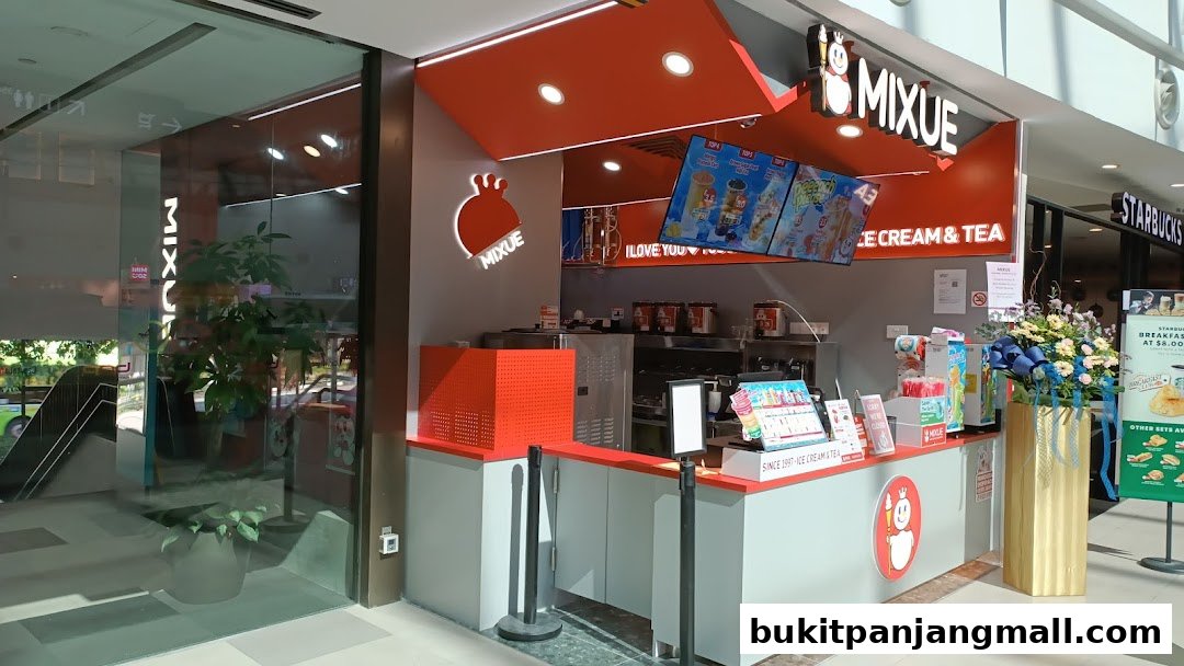 The exterior of a Mixue ice cream and tea shop with bright orange branding and menu displays.