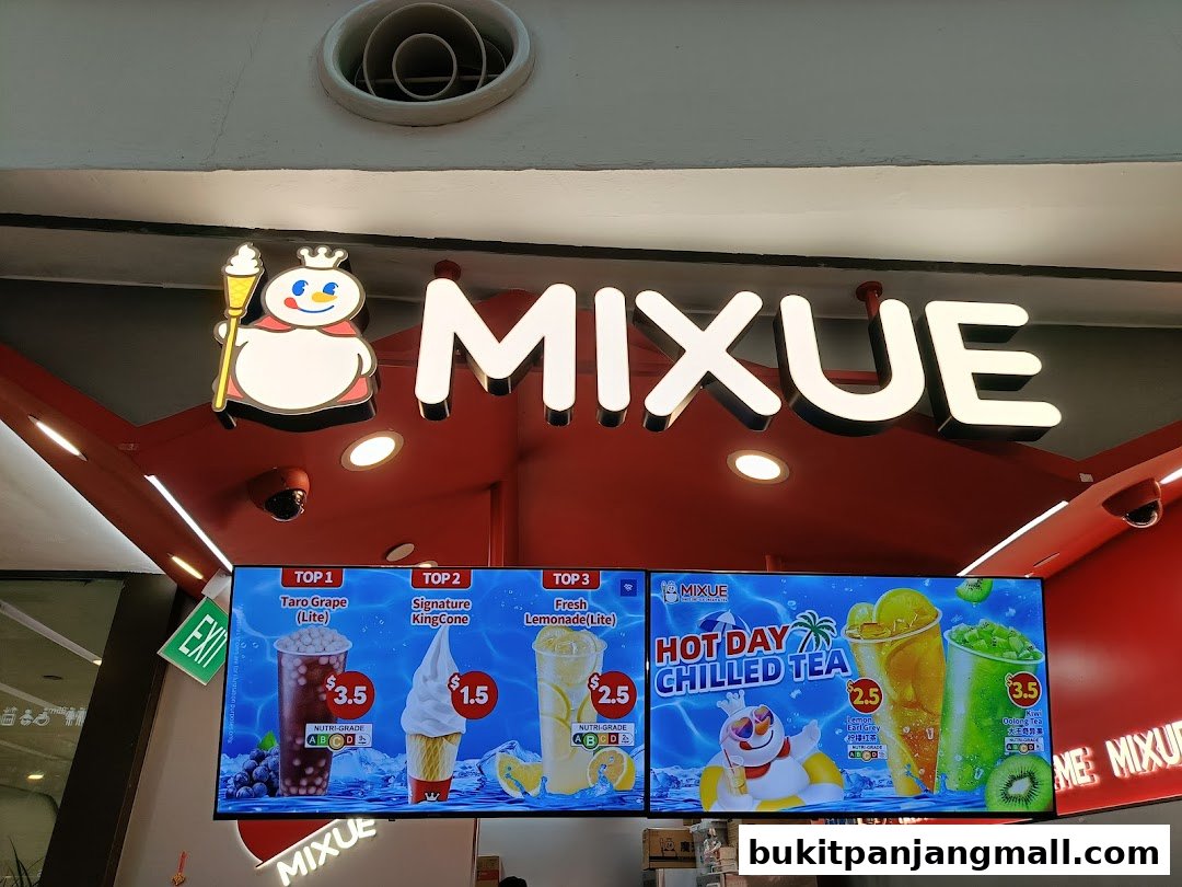 The MIXUE shop front with illuminated signage and a digital menu displaying drinks and ice cream.