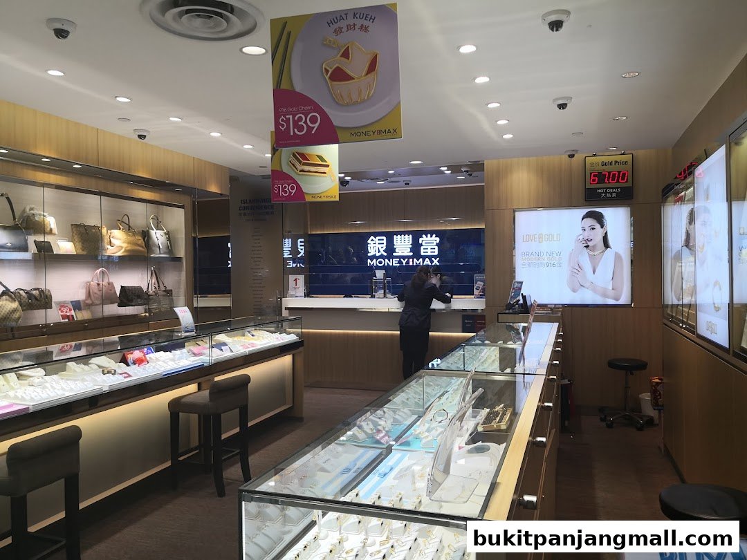 Interior of a MoneyMax Pawnshop showcasing jewelry displays and promotional materials.