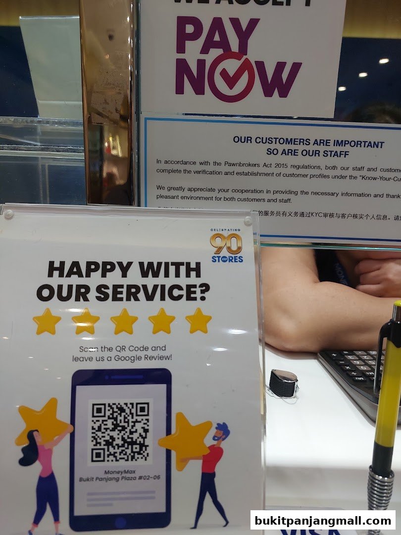 A sign encouraging customers to leave a Google review for MoneyMax Pawnshop, Bukit Panjang Plaza.