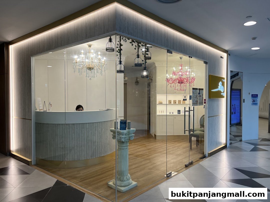 The entrance of a modern spa with elegant chandeliers and a reception desk.