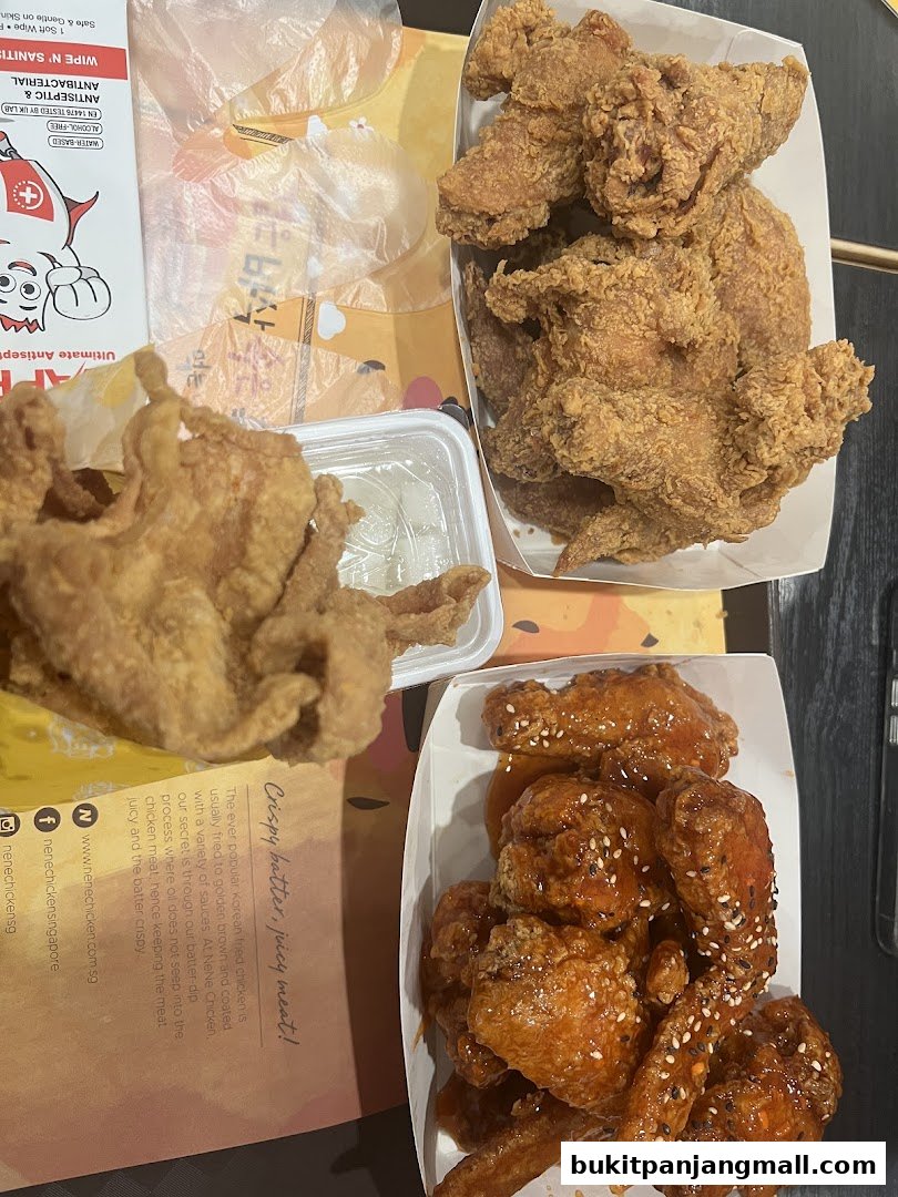 A top-down view of various Korean fried chicken dishes from NeNe Chicken.