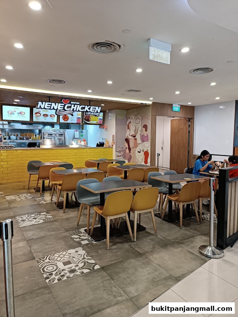 Interior view of NeNe Chicken restaurant with tables, chairs, and counter.