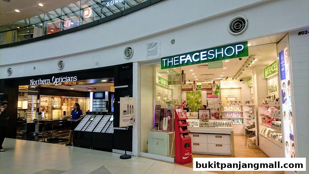 Exterior view of Northern Opticians and The Face Shop stores in a mall.