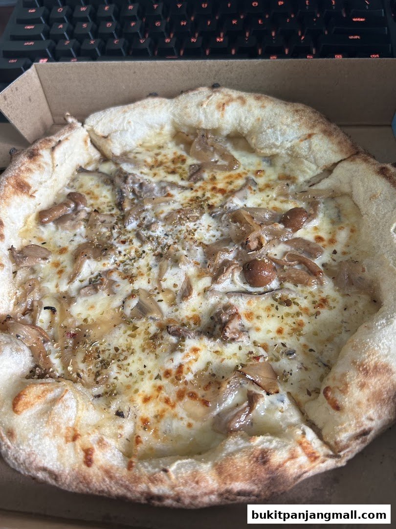 A close-up shot of a delicious mushroom pizza in a cardboard box.